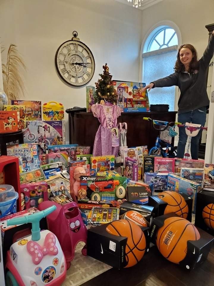 Teen-age girl standing in office full of colorful toys