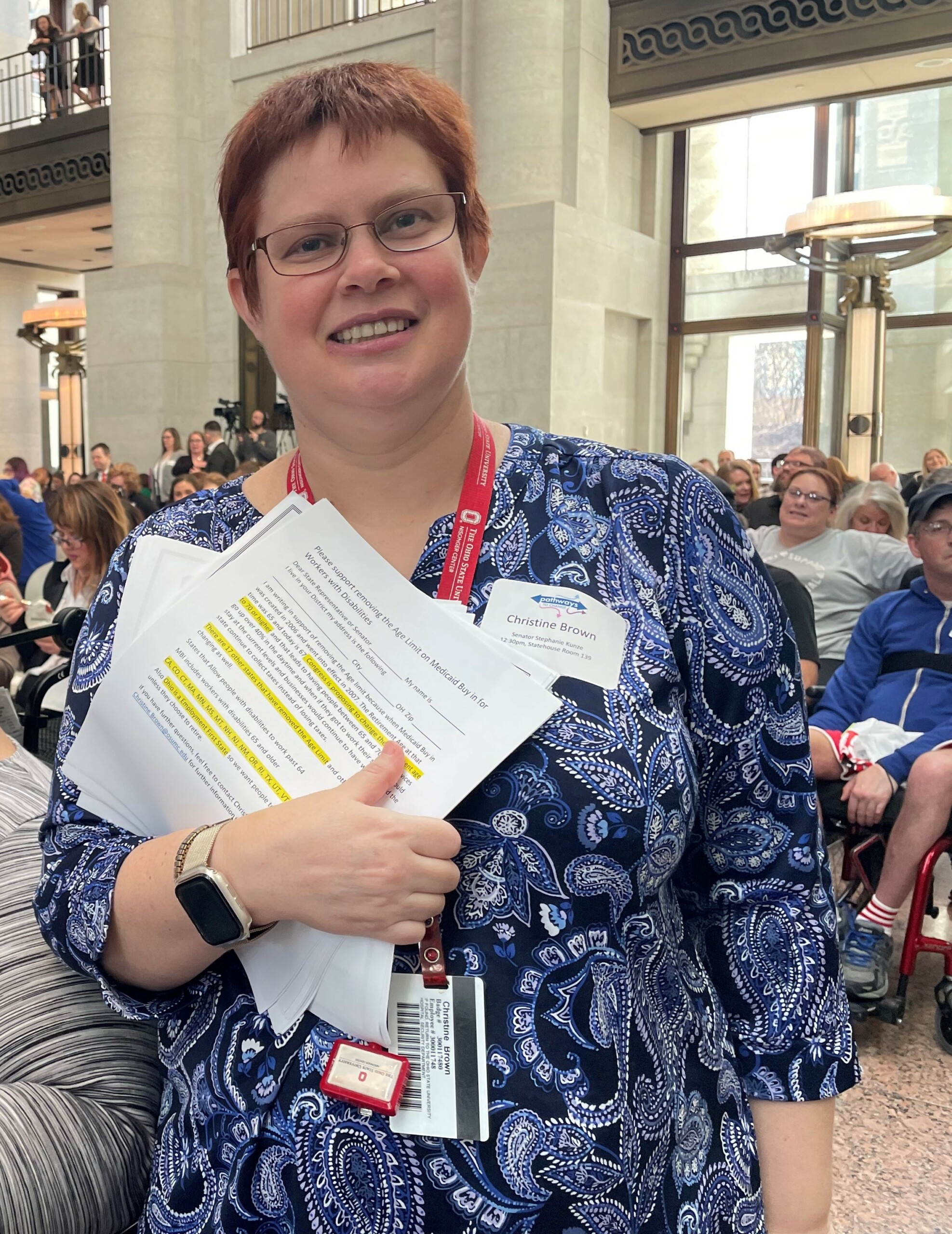 Woman standing in atrium of Ohio Statehouse during an advocacy event.